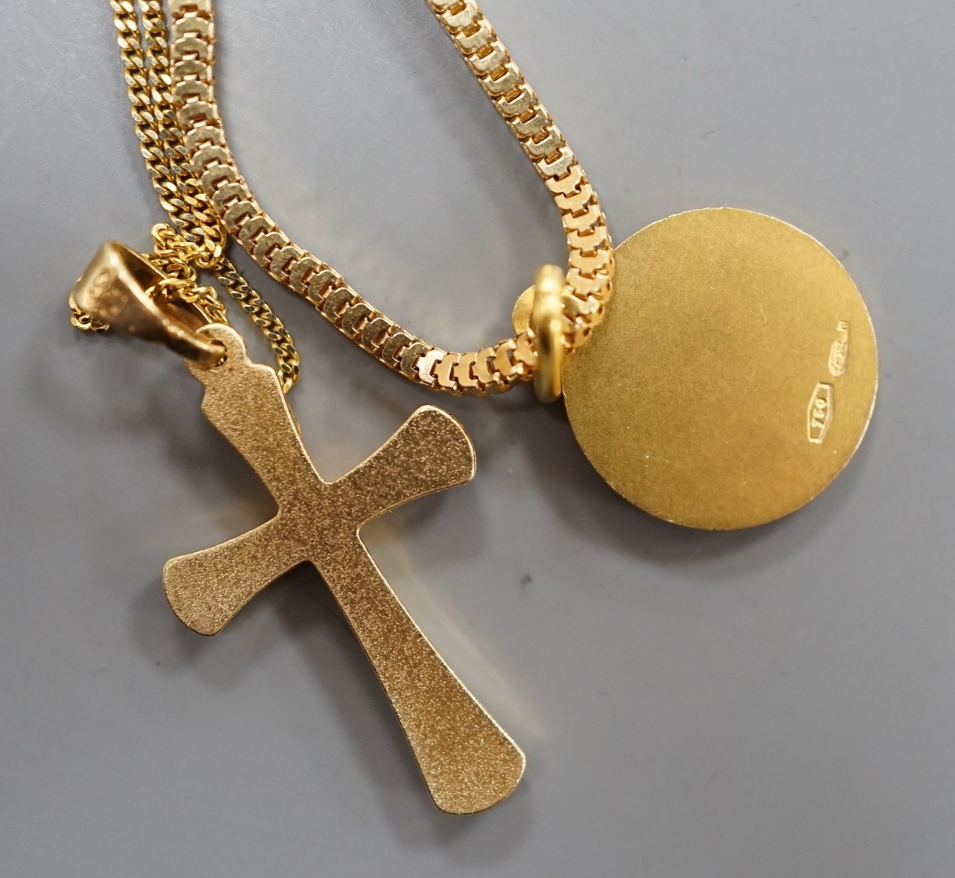 A modern Italian 750 yellow metal pendant on chain, gross 7.7 grams and a 375 cross pendant on a 9ct chain, 1.9 grams.